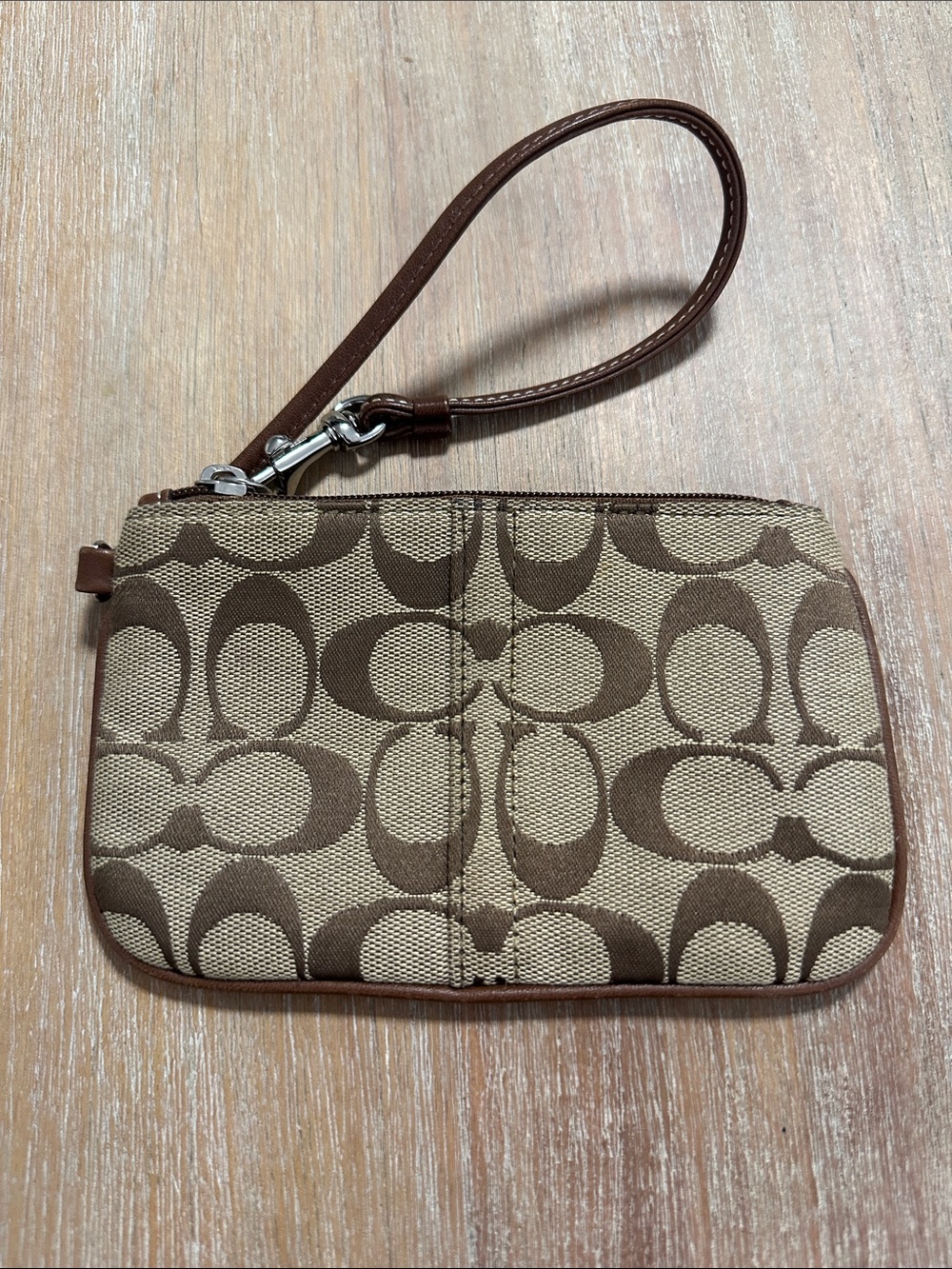 Coach Brown Signature Canvas Wristlet with Tan Background